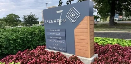 Custom multi-tenant monument sign for Parkwood 7 office park in Indianapolis featuring a dark panel with dimensional lettering and tenant directory, designed and installed by Eye 4 Group
